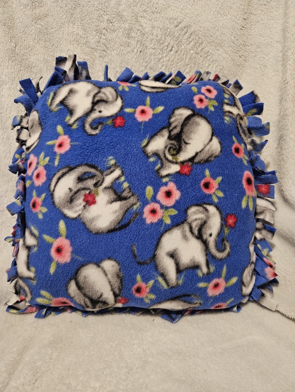 Handmade cobalt blue fleece accent pillow with elephants & pink flowers.